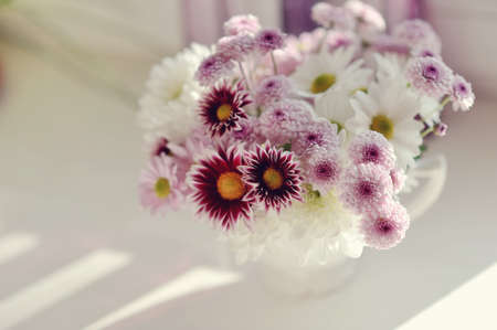 beautiful delicate bouquet of pink chrysanthemums in a blue bucketの写真素材