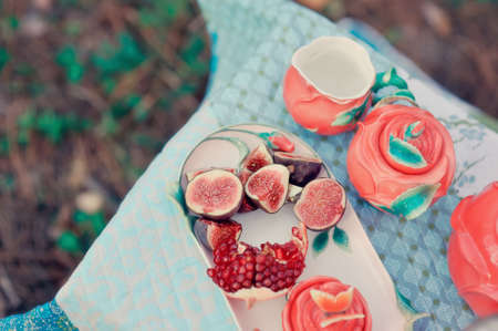 still life - red, juicy pomegranate and fresh, ripe figs