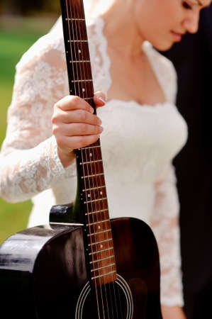 bride in a white dress holding a hand guitarの写真素材