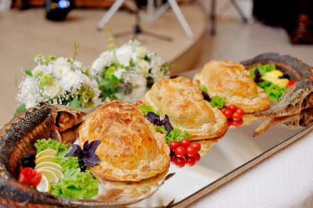 beautifully designed holiday dish with stuffed fish and piesの写真素材
