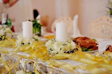 banquet table with large white flowers beautifully decoratedの写真素材