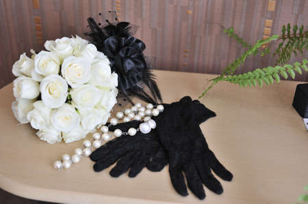 composition-white bouquet of roses and black glovesの写真素材