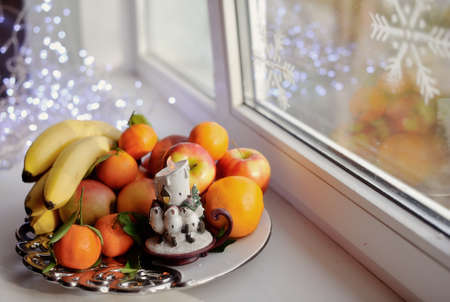 on the window still life fruit on a platter with a candleの写真素材