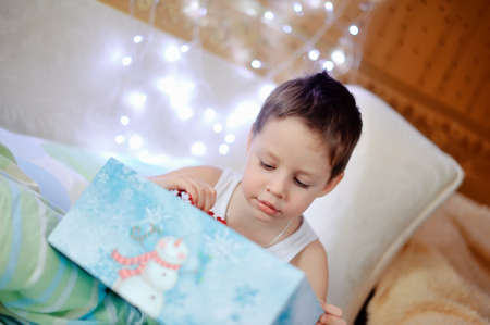 boy woke up in his bed and was a Christmas giftの写真素材