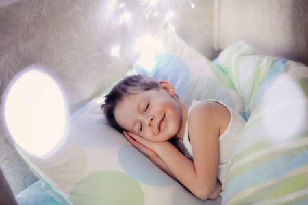 little boy sleeping in a cozy bed child