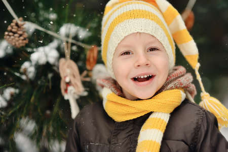 portrait of a boy in a cap on a background of winter treesの写真素材