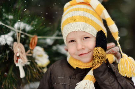 portrait of a boy in a cap on a background of winter treesの写真素材