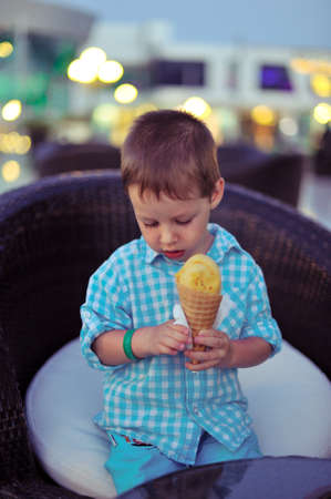 against the evening of boy eating ice creamの写真素材