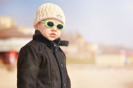 boy in sunglasses and black coat on the natureの写真素材