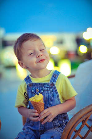 against the evening of boy eating ice creamの写真素材
