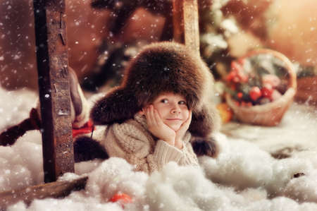 creative photo card is a smiling boy in a fur hatの写真素材