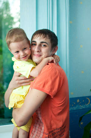 gently and kindly young man hugging his little nephewの写真素材