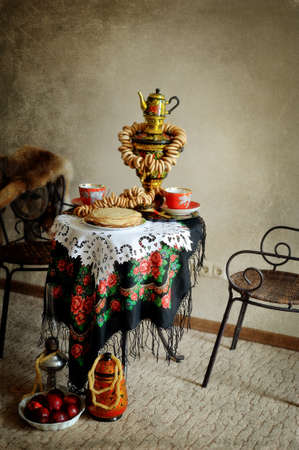 still life on the table is a samovar with bagels and pancakesの写真素材