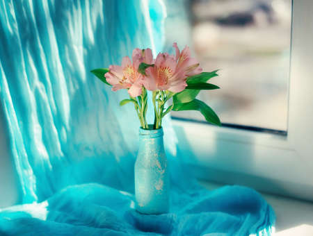 on a blue background and a blue vase delicate ornamental flowers