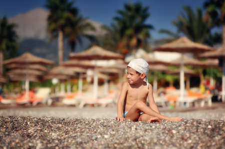 The child on the sea in a hat has a rest in the summerの写真素材