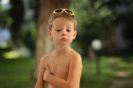 emotional portrait of a handsome boy in the summer outdoorsの写真素材