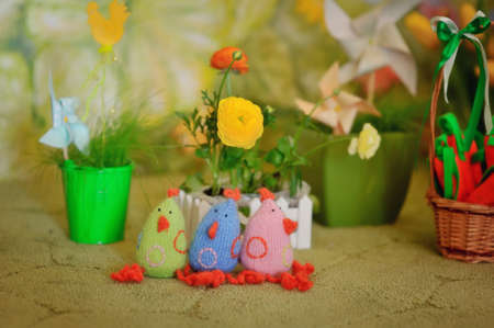 Easter flower arrangement and a toy chickensの写真素材