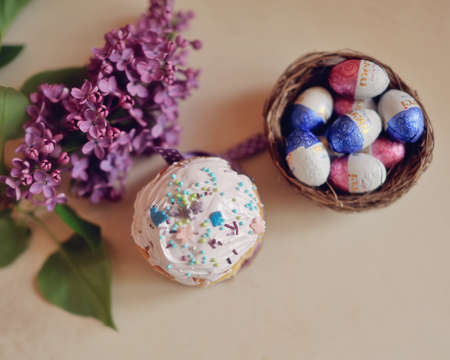 Easter composition, beautiful cakes with colored eggs and lilac