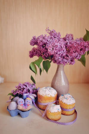 Easter composition, beautiful cakes with colored eggs and lilacの写真素材