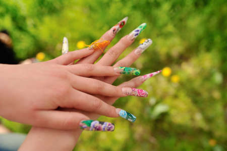 against the background of flowering branches of women s hands with a nice manicure different pictureの写真素材