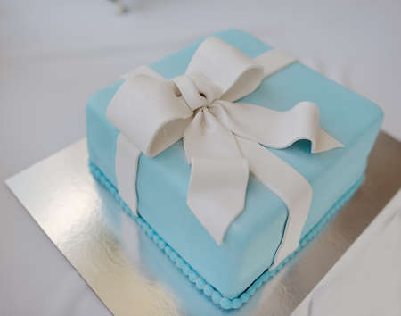 cake on a white background as a blue box with a white ribbonの写真素材