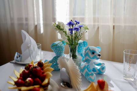 children s banquet table with blue teddy bears and fruitの写真素材