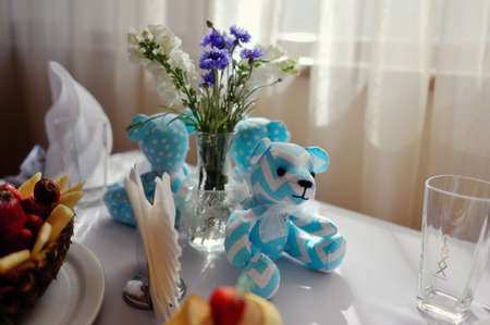children s banquet table with blue teddy bears and fruitの写真素材