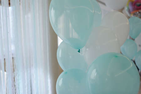 a window with a gentle air curtains lot of blue and white balloonsの写真素材