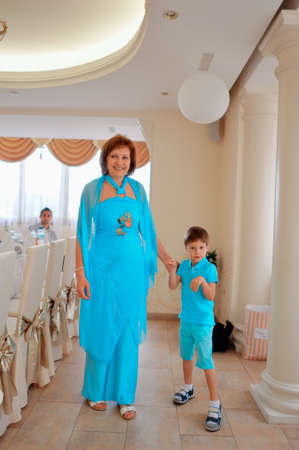 in the banquet hall of a happy and cheerful family in blue costumesの写真素材