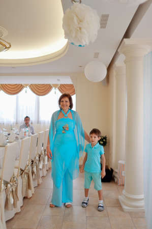 in the banquet hall of a happy and cheerful family in blue costumesの写真素材