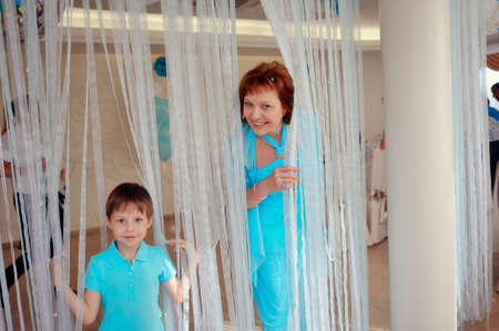 cheerful family in a blue suit on a background of snowy curtainsの写真素材