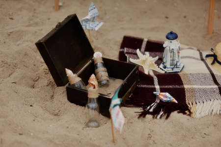 marine still life on the sand box with bottles, shells and starfishの写真素材