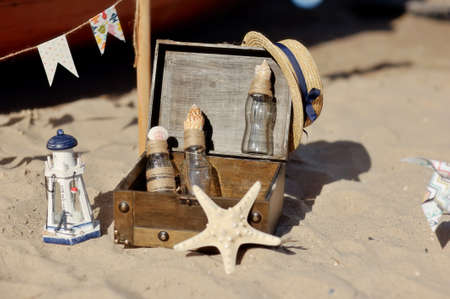 marine still life on the sand box with bottles, shells and starfishの写真素材