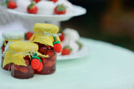 on the nature of the banks on a white table with strawberry jam and a bowl of marshmallowsの写真素材