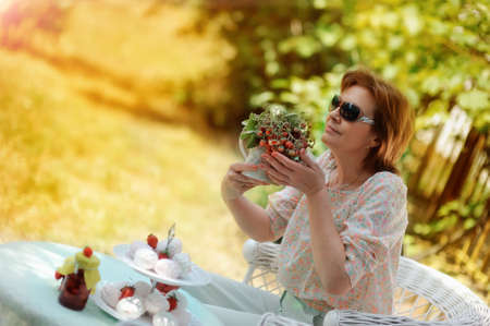 woman hold strawberry vaseの写真素材