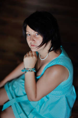 portrait of a glamorous woman in a turquoise dress with a stylish haircutの写真素材