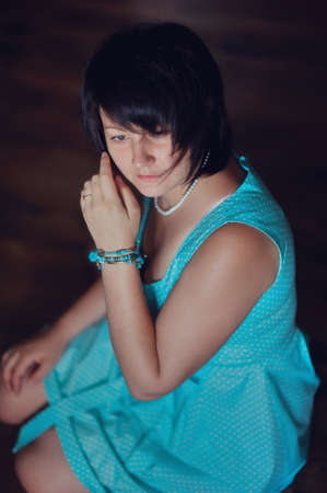 portrait of a glamorous woman in a turquoise dress with a stylish haircutの写真素材