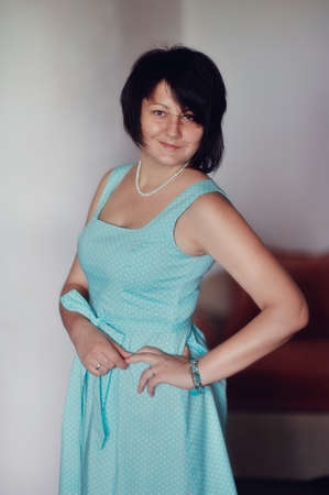 portrait of a glamorous woman in a turquoise dress with a stylish haircutの写真素材