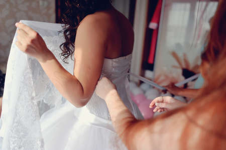 the bride wearing a wedding dress and lace up corsetの写真素材