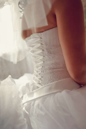 the bride wearing a wedding dress and lace up corsetの写真素材