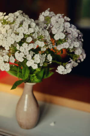 on the window sill is a bouquet of pink roses in a beautiful decorative vase