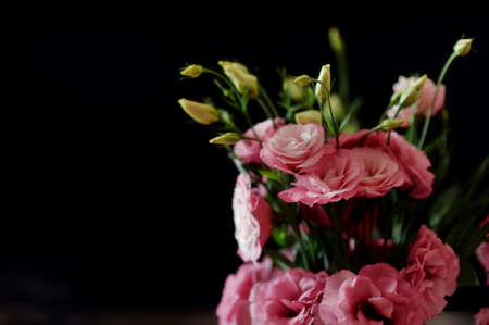 on a black background decorative bouquet of pink flowersの写真素材
