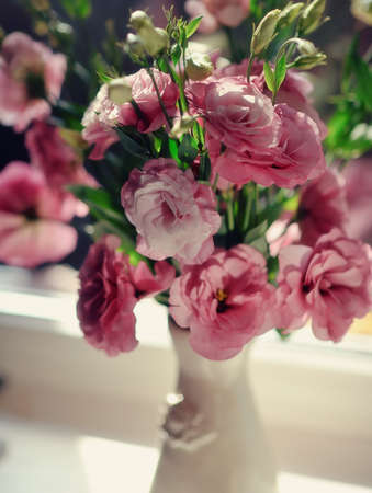 close-up of a bouquet of pink roses in a beautiful decorative vaseの写真素材