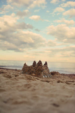 against the beautiful cloudy sky on the beach sand castleの写真素材