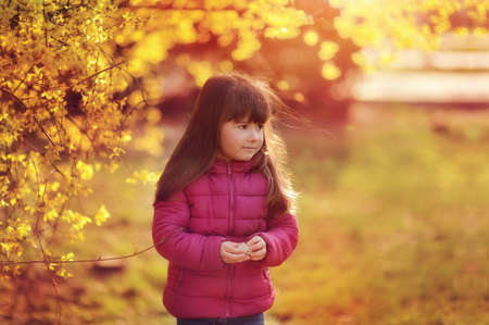 on the nature of the park in the sunshine is a little girl