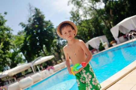 in a recreation area azure pool boy in a straw hatの写真素材