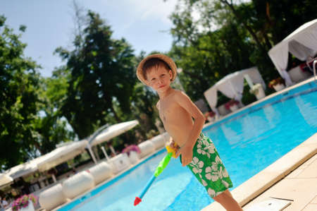in a recreation area azure pool boy in a straw hatの写真素材