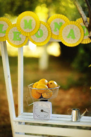 on the background of nature white wooden counter with the inscription, and scales with lemonの写真素材