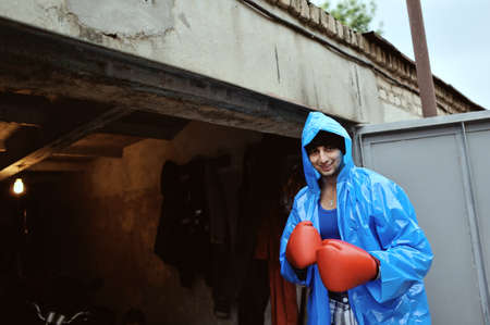 guy in the blue coat with red boxing gloves