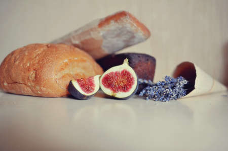 Still crisp bread, fresh figs and a bouquet of dry lavenderの写真素材